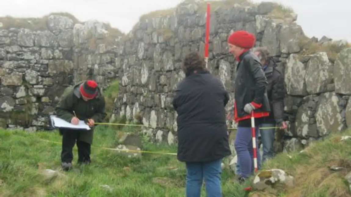 Participants measuring an archaeological sie