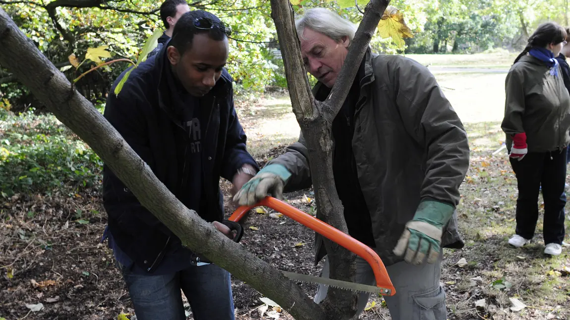 Trainer showing participant how to prune a tree