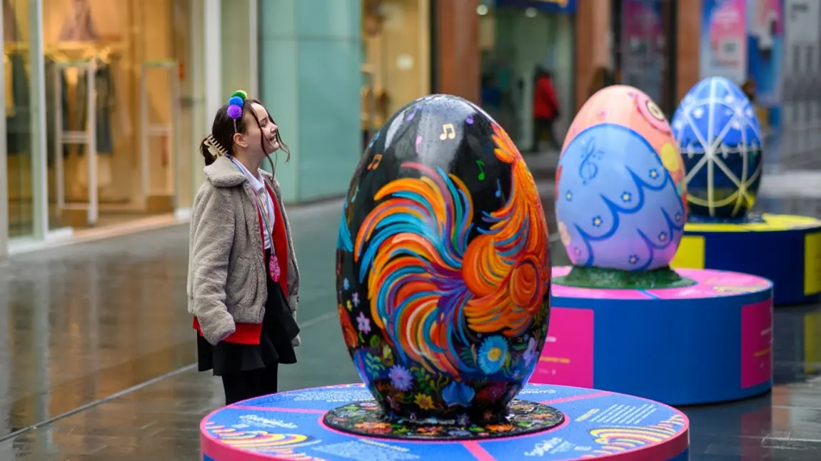 Children stand next to pysanka egg display for Eurovision celebrations