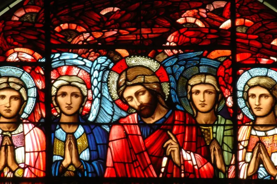 A stained glass window depicting a scene of Christ